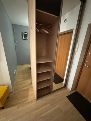 a walk in closet in a room with wooden floors at Cozy Ozo Park Apartment, Pet Friendly with Workspace in Vilnius