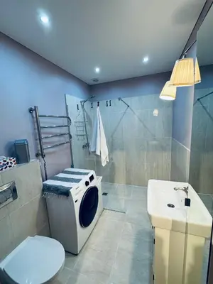 a bathroom with a shower and a toilet and a sink at Cozy Ozo Park Apartment, Pet Friendly with Workspace in Vilnius