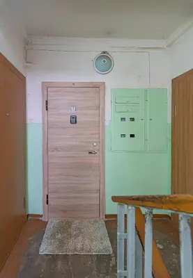 a room with a wooden door and a wall at Apartment Lampėdis by Polo Apartments in Kaunas