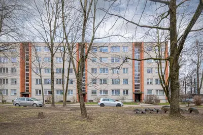 two cars parked in front of a large building at Apartment Lampėdis by Polo Apartments in Kaunas