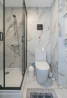 a bathroom with a toilet and a shower at Apartment Lampėdis by Polo Apartments in Kaunas