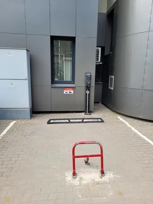 a red rack in a parking lot next to a building at Maironio 21A apartments - City center - Free parking in Kaunas