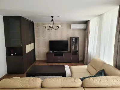 a living room with a couch and a flat screen tv at Maironio 21A apartments - City center - Free parking in Kaunas
