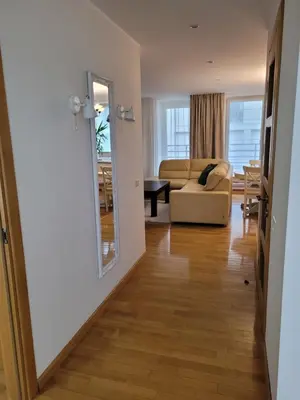 a living room with a couch and a mirror at Maironio 21A apartments - City center - Free parking in Kaunas