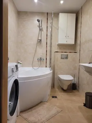 a bathroom with a washing machine and a toilet at Maironio 21A apartments - City center - Free parking in Kaunas