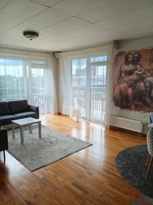 a living room with a couch and a painting on the wall at kabantys sodai in Vilnius