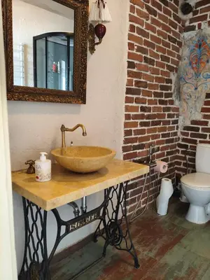 a bathroom with a sink with a mirror and a toilet at kabantys sodai in Vilnius