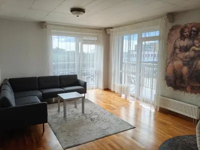 a living room with a couch and a painting on the wall at kabantys sodai in Vilnius