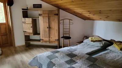 a bedroom with two beds and a wooden ceiling at Hunters Lounge Apartments