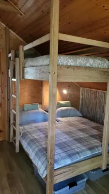 a bedroom with two bunk beds in a cabin at Hunters Lounge Apartments