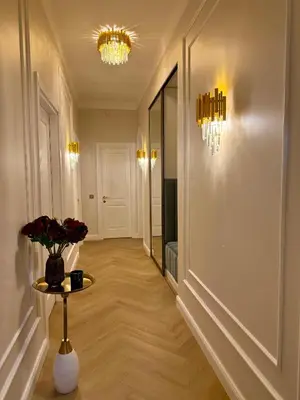 a hallway with a vase of flowers on a table at KR Apartment Kaunas in Kaunas