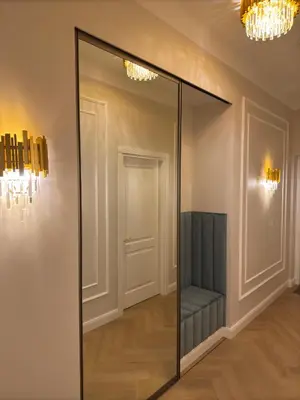 a mirror in a room with a bench in it at KR Apartment Kaunas in Kaunas
