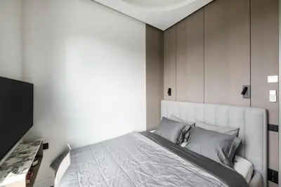 a bedroom with a large bed with a white headboard at Sky&River Towe Apartments Kaunas City Center in Kaunas