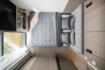 a small bedroom in a tiny house at Sky&River Towe Apartments Kaunas City Center in Kaunas