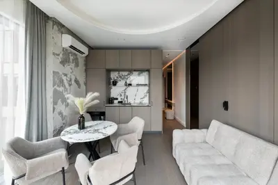 a living room with a couch and a table and chairs at Sky&River Towe Apartments Kaunas City Center in Kaunas