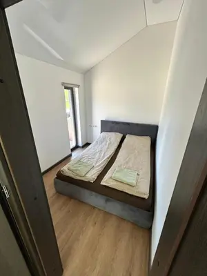 a bedroom with a bed in a small room at Pasienio krantas in Velūnai