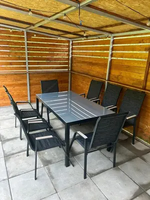 a table and chairs on a patio at Pasienio krantas in Velūnai