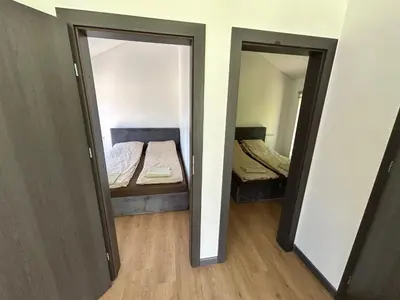 a small room with a bed and a mirror at Pasienio krantas in Velūnai