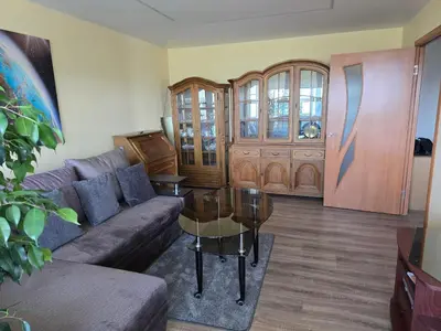a living room with a couch and a table at Apartaments Kaunas in Kaunas