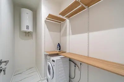 a laundry room with a washer and dryer at Modern Loft Apartment with free parking No4 in Marijampolė