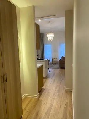 a room with a kitchen and a living room at Modern Loft Apartment with free parking No4 in Marijampolė