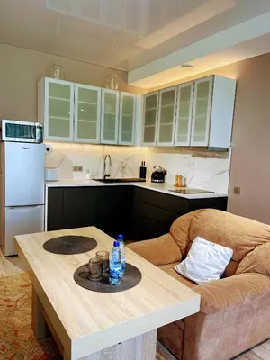 a kitchen with a table and a couch at Family room in Vilnius