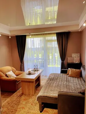 a bedroom with a bed and a couch and a table at Family room in Vilnius