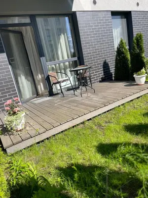 a porch with two chairs and a table on it at Family room in Vilnius