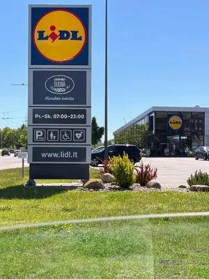 a sign for aldi in a parking lot at Family room in Vilnius