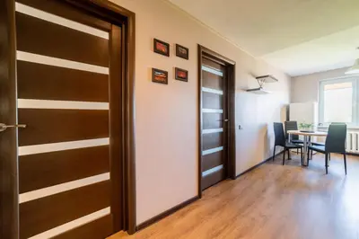 a door leading to a dining room with a table at Blue Sky Apartments in Šiauliai