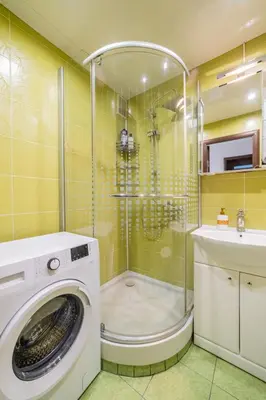 a washing machine in a bathroom with a shower at Blue Sky Apartments in Šiauliai