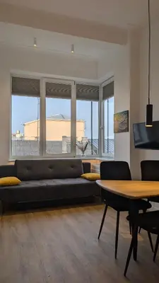 a living room with a couch and a table at Kaunas City Centre Apartment Self Check-In & AC in Kaunas