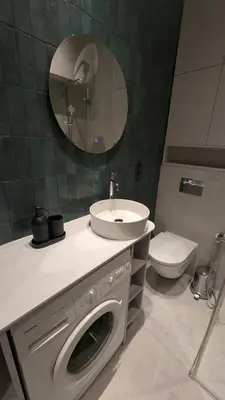 a bathroom with a washing machine and a sink at Kaunas City Centre Apartment Self Check-In & AC in Kaunas