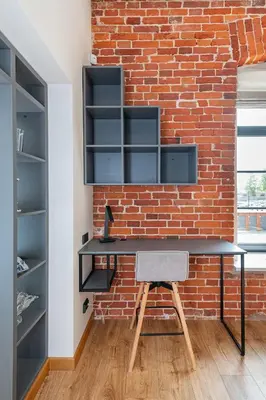 an office with a brick wall and a desk at Shanti barracks apartment #3 by Polo Apartments in Kaunas