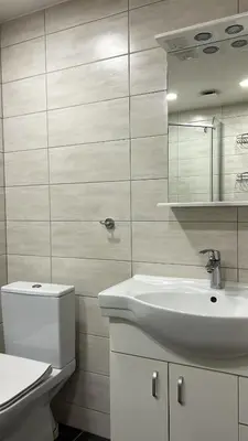 a white bathroom with a sink and a toilet at Rugilės lelijų apartamentai in Birštonas