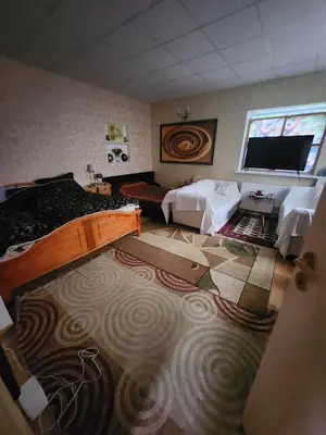 a bedroom with two beds and a flat screen tv at Unesco Kaukas in Kaunas