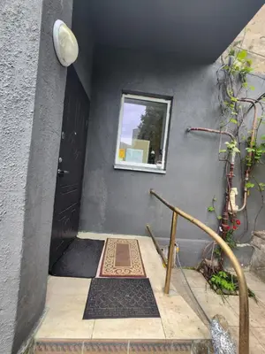 a stairway with a black door and a window at Unesco Kaukas in Kaunas