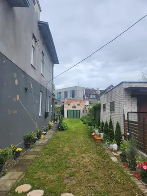 a yard with potted plants next to a building at Unesco Kaukas in Kaunas