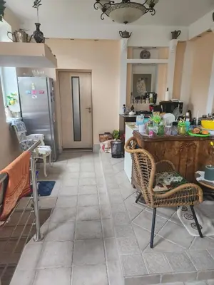 a kitchen with a counter and a table and chairs at Unesco Kaukas in Kaunas