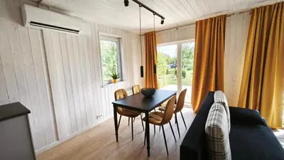 a living room with a table and a couch at Gervių takas 1