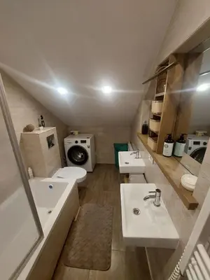a bathroom with two sinks and a toilet at Fryko apartamentai Kaune in Kaunas