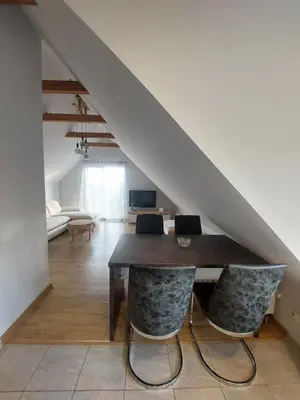 a dining room with a table and two chairs at Fryko apartamentai Kaune in Kaunas