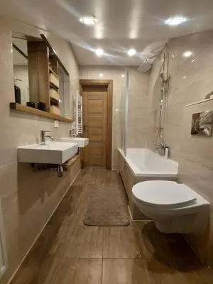 a bathroom with two sinks and a toilet and a tub at Fryko apartamentai Kaune in Kaunas