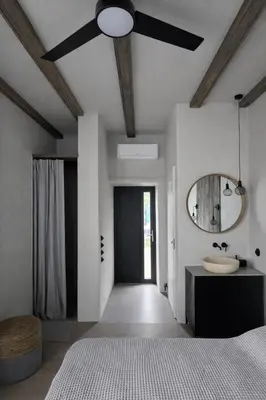 a bedroom with a ceiling fan and a mirror at Central Downtown Terrace Studio in Šiauliai