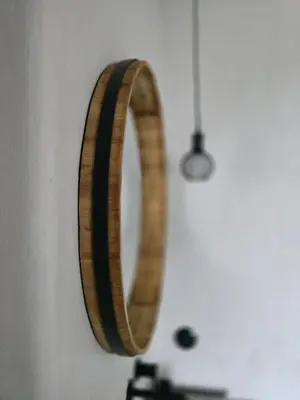 a wooden mirror hanging on a wall at Central Downtown Terrace Studio in Šiauliai