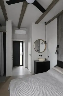 a bedroom with a bed and a mirror and a sink at Central Downtown Terrace Studio in Šiauliai