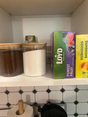 a shelf with a roll of toilet paper and a book at Vilnius Central Living – Jakšto place in Vilnius