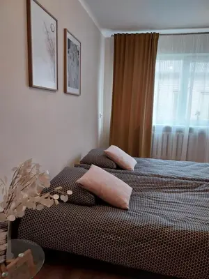 two beds in a bedroom with two pillows on them at Saulės miesto apartamentai in Šiauliai