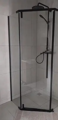 a stand up shower with a glass door in a room at Saulės miesto apartamentai in Šiauliai