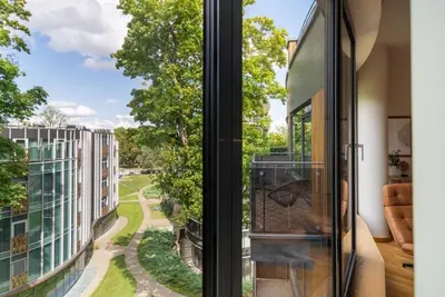 a room with a window with a view of a street at 2 Bedroom Apt with Balconies in Druskininkai